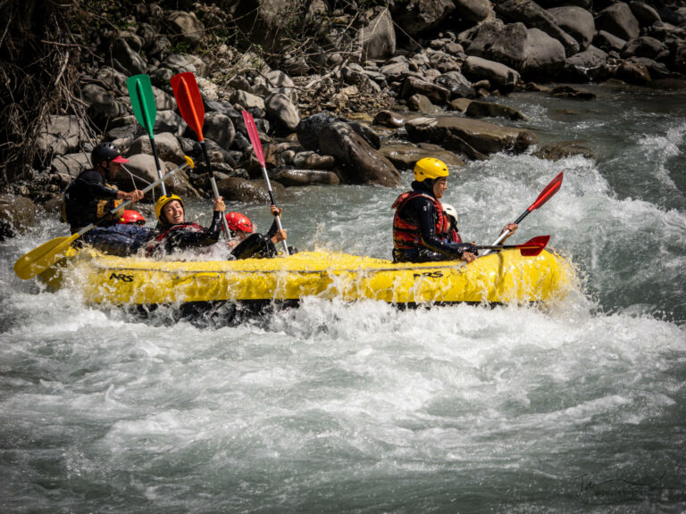 un raft jaune descend la rivière dans les Alpes